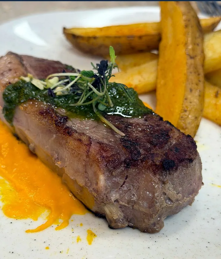 Steak with potatoes and herb sauce