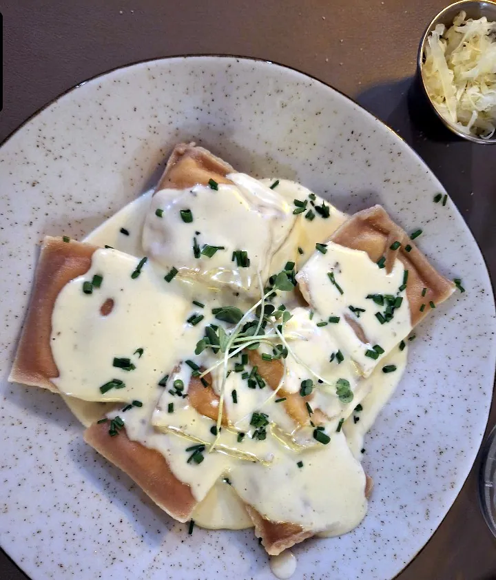 Ravioli with creamy sauce and fresh herbs